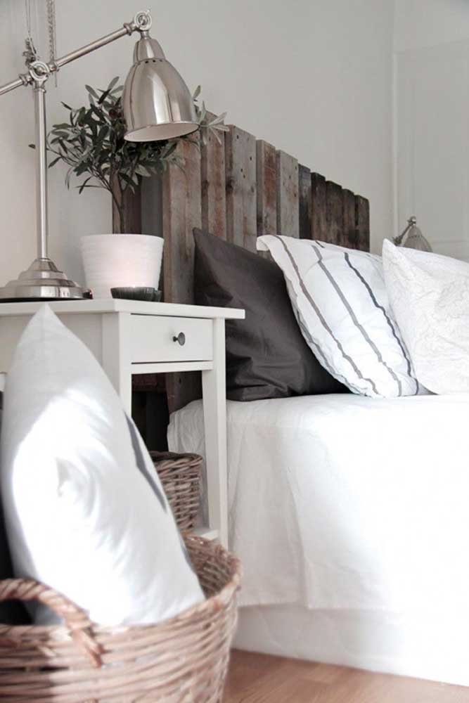 Já esse quarto de decoração clean apostou em uma cabeceira de pallet escuro