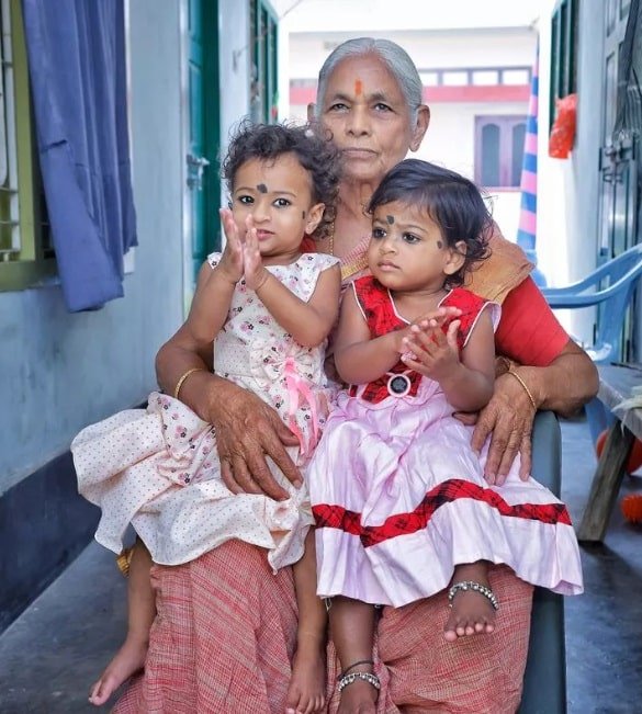 Mãe junto com as filhas gêmeas que teve com 73 anos